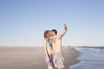 Casal tomando auto retrato na praia, Breezy Point, Queens, Nova York, EUA — Fotografia de Stock