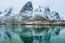 Edifici e montagne innevate, Reine, Lofoten, Norvegia — Foto stock