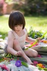 Девушка с папоротником делает цветок и листья дисплей в саду — стоковое фото