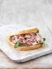 Ham, sliced gherkins and radish sandwich of white bread — Stock Photo