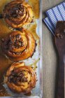 Top view of three sticky buns on baking tray — Stock Photo