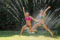 Ragazze adolescenti che giocano a sprinkler — Foto stock