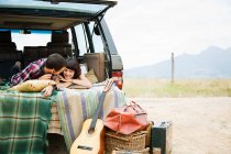 Couple lying in back of suv — Stock Photo