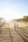 Mature lesbian couple walking through ranch at sunset — Stock Photo