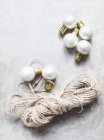 Top view of white christmas baubles with string — Stock Photo
