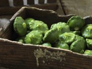 Fresh organic vegetable, green pattypan squash on crate — Stock Photo