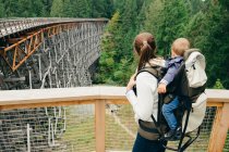 Giovane donna che porta il figlio sul retro, Kinsol Trestle Bridge, British Columbia, Canada — Foto stock