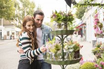 Couple at florist shop outdoors — Stock Photo