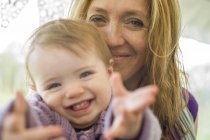 Portrait of mother and daughter looking at camera smiling — Stock Photo