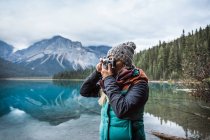 Mujer fotografiando, Emerald Lake, Parque Nacional Yoho, Campo, Columbia Británica, Canadá - foto de stock