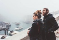 Couple looking out over misty canal, Venice, Italy — Stock Photo