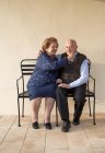 Senior woman pinching man's cheek — Stock Photo