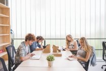 Co-workers working in open plan office together — Stock Photo