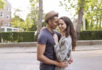 Young couple in street hugging — Stock Photo