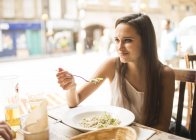 Young woman having lunch in restaurant — Stock Photo