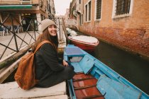 Donna seduta vicino al canale, Venezia, Italia — Foto stock