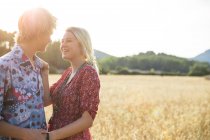 Romantic young couple holding hands in wheat field, Majorca, Spain — Stock Photo