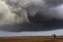 Thunderstorm and funnel cloud in countryside field — Stock Photo