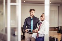 Two businessmen chatting in boardroom — Stock Photo
