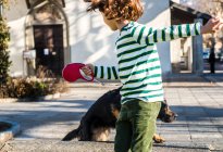 Boy playing with his best friend, his pet dog — Stock Photo