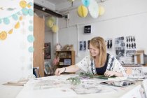 Designer féminin préparant la conception mixte dans le studio de presse à imprimer — Photo de stock