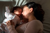 Mother and son resting in bed — Stock Photo
