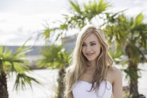 Beautiful long blond haired young woman in city — Stock Photo