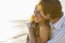 Romantic young couple on sunlit beach, Majorca, Spain — Stock Photo