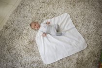 Swaddling Step 1. Baby boy lying on blanket — Stock Photo
