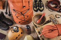 Top view of prepared climbing equipment with rucksack, climbing boots and climbing rope — Stock Photo