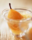Poached pear and granita with crushed ice in glass — Stock Photo