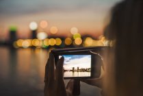 Young woman photographing view with smartphone, close-up of screen — Stock Photo