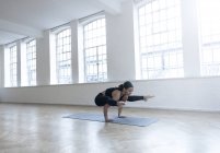 Woman in dance studio in yoga position — Stock Photo