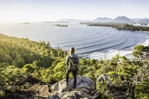 Elevated view of female hiker looking out from coastal forest, Pacific Rim National Park, Vancouver Island, British Columbia, Canada — Stock Photo