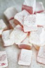 Stacked rose and lemon turkish delight covered in icing sugar — Stock Photo