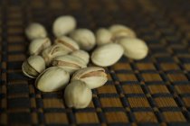 Close up shot of pistachio nuts on table — Stock Photo