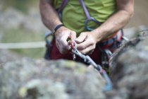 Cropped view of rock climber preparing climbing rope — Stock Photo