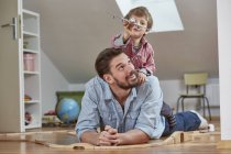 Father and son playing with toy aeroplane — Stock Photo
