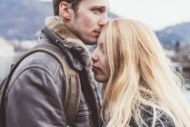 Romantischer junger Mann küsst Freundinnen Stirn, Lake Como, Italien — Stockfoto