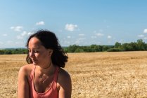 Portrait of woman looking down in front of field, France — Stock Photo