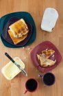 Coffee cups and toasts on table, top view — Stock Photo