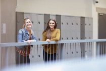 Portrait of two female students in higher education college locker room — Stock Photo
