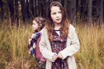 Portrait of two young standing in meadow — Stock Photo