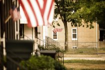 Piccola strada cittadina con bandiere americane sulle case — Foto stock