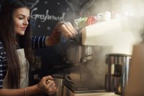 Barista making coffee in cafe — Stock Photo