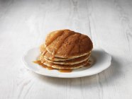 Stack of pancakes drizzled with butterscotch sauce — Stock Photo