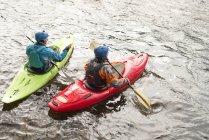 Male and female kayakers paddling on River Dee — Stock Photo