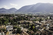 Buildings by tree covered mountains, Meran, South Tyrol, Italy — Stock Photo