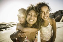Happy mother and children on beach — Stock Photo
