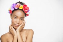Porträt einer Frau mit Blumen-Stirnband, die in die Kamera blickt — Stockfoto